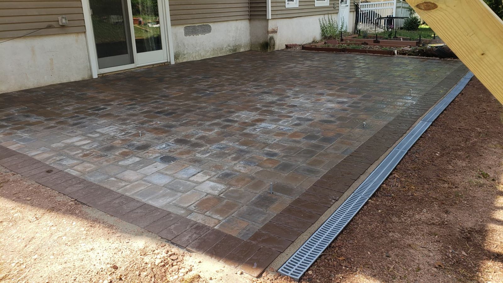 Front yard hardscape build with paver landing, steps and river rock beds in New Jersey