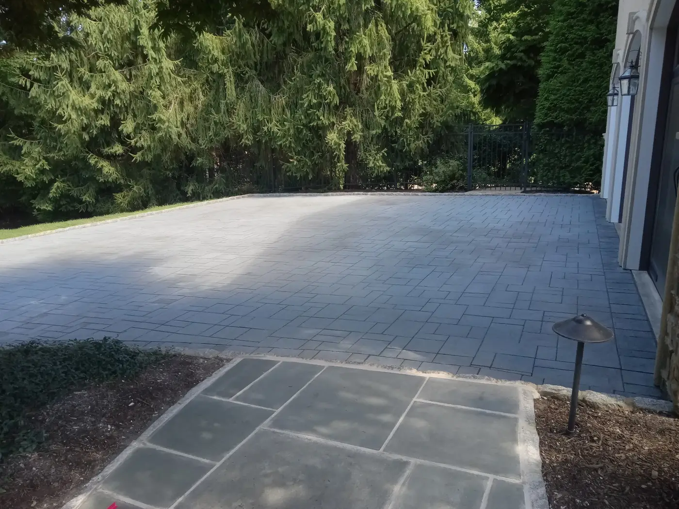 Custom paver patio with stone retaining wall and ambient lighting