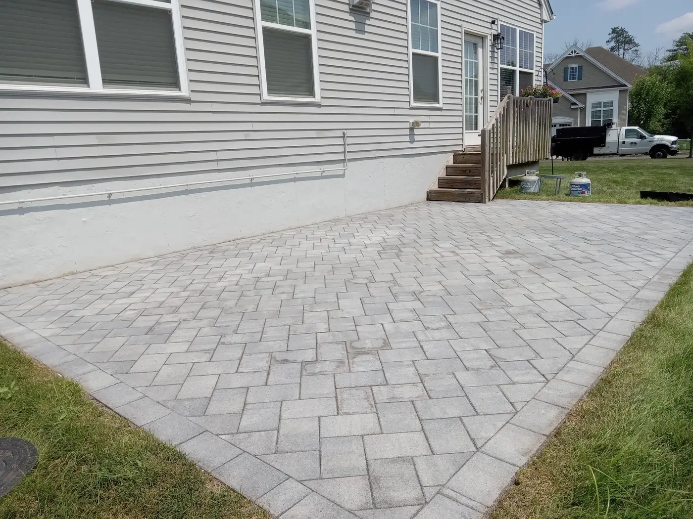 Curved paver walkway leading to landscaped garden entrance