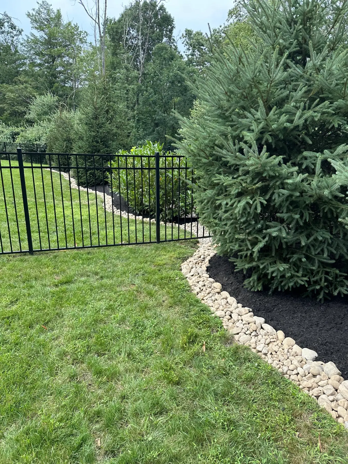 Layered foundation planting bed and lawn on a Central New Jersey property